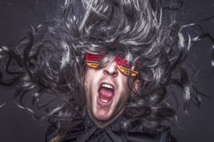 Excited rocking man with 80's sunglasses.